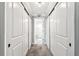 Hallway with closet space and entrance to bathroom with neutral interior at 400 Island Way # 502, Clearwater Beach, FL 33767