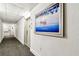 Hallway with carpet and textured walls leading to unit 502, decorated with a painting at 400 Island Way # 502, Clearwater Beach, FL 33767