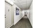 Hallway with carpet leading to unit 502, with view down the hallway at 400 Island Way # 502, Clearwater Beach, FL 33767