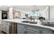 Stylish condo featuring kitchen with stainless steel appliances, light gray cabinets and a breakfast bar at 400 Island Way # 502, Clearwater Beach, FL 33767