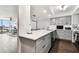 Kitchen with dining table featuring stainless steel appliances, light grey cabinets, and bar seating at 400 Island Way # 502, Clearwater Beach, FL 33767