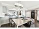 Beautiful open concept kitchen and dining area with stainless steel appliances, white cabinets, and hardwood floors at 400 Island Way # 502, Clearwater Beach, FL 33767