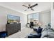 This multi-purpose area features a sleek workspace, comfortable seating, and stylish ceiling fan at 400 Island Way # 502, Clearwater Beach, FL 33767