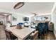Bright living room with tile floors, ceiling fan, dining table and chairs, plus sliding doors to the balcony with a view at 400 Island Way # 502, Clearwater Beach, FL 33767