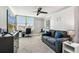 Versatile living area with sleek ceiling fan, blends relaxation with a functional workspace bathed in natural light at 400 Island Way # 502, Clearwater Beach, FL 33767