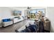 Bright living room with balcony access, entertainment center, and comfortable furnishings at 400 Island Way # 502, Clearwater Beach, FL 33767