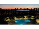 Night view of the community pool and the waterway with city lights in the distance at 400 Island Way # 502, Clearwater Beach, FL 33767