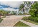 Resort-style pool area with lush landscaping and comfortable lounge seating at 400 Island Way # 502, Clearwater Beach, FL 33767