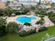 Overhead view of the community pool with beach chairs and palm trees at 400 Island Way # 502, Clearwater Beach, FL 33767