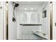 Contemporary shower boasts sleek white tile, a convenient grab bar, and a built-in corner seat at 400 Island Way # 502, Clearwater Beach, FL 33767