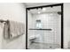 Walk-in shower with white tile surround and black trim at 400 Island Way # 502, Clearwater Beach, FL 33767