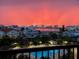 Beautiful sunset view from balcony overlooking pool area and scenic waterfront cityscape at 400 Island Way # 502, Clearwater Beach, FL 33767