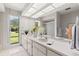 Bright bathroom with double vanity, large mirror, and lots of natural light at 440 Lakeview Dr # 34, Palm Harbor, FL 34683