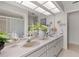 Well-lit bathroom with double sinks, vanity, and a shower, offering a comfortable and functional space at 440 Lakeview Dr # 34, Palm Harbor, FL 34683