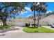 Attractive home exterior featuring a well-maintained lawn, a driveway, and a two-car garage at 440 Lakeview Dr # 34, Palm Harbor, FL 34683
