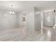 Inviting open-concept living area with modern lighting and a clear view of the kitchen and front door at 440 Lakeview Dr # 34, Palm Harbor, FL 34683