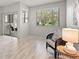 Bright living room with wood-look floors, a large window, and stylish decor at 440 Lakeview Dr # 34, Palm Harbor, FL 34683