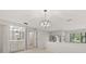 Open concept living space with wet bar, modern chandelier, and views to the exterior at 440 Lakeview Dr # 34, Palm Harbor, FL 34683