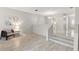 Bright living room with hardwood floors, a chic armchair, and a staircase leading to the upper level at 440 Lakeview Dr # 34, Palm Harbor, FL 34683