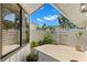 Serene outdoor patio featuring pavers, a privacy fence, and lush tropical landscaping at 440 Lakeview Dr # 34, Palm Harbor, FL 34683