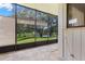 Screened patio with views of pond, landscaping, and distant buildings at 440 Lakeview Dr # 34, Palm Harbor, FL 34683