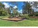 Community playground with slides, climbing structures, and soft ground cover at 440 Lakeview Dr # 34, Palm Harbor, FL 34683