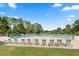 Community pool with plenty of lounge chairs for relaxing and enjoying the sun at 440 Lakeview Dr # 34, Palm Harbor, FL 34683
