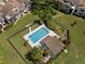 Aerial view of the community pool area surrounded by lush landscaping and greenery at 440 Lakeview Dr # 34, Palm Harbor, FL 34683