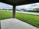Spacious backyard with a well-maintained lawn and a white fence, as seen from the covered patio at 4448 Globe Thistle, Tampa, FL 33619