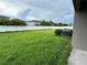 Backyard featuring a large grassy area enclosed by a white fence at 4448 Globe Thistle, Tampa, FL 33619