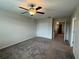 Carpeted bedroom with ceiling fan, closet, and a view of the landing at 4448 Globe Thistle, Tampa, FL 33619