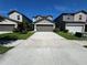 Charming two-story home with landscaped front yard and spacious driveway leading to a two car garage at 4448 Globe Thistle, Tampa, FL 33619