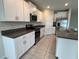 Modern kitchen with white cabinets, stainless steel appliances, and granite countertops at 4448 Globe Thistle, Tampa, FL 33619