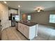 Open kitchen with granite countertops, white cabinets, stainless steel appliances, tile floors and an island at 4448 Globe Thistle, Tampa, FL 33619