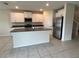 Spacious kitchen featuring white cabinets, stainless steel appliances, dark countertops and tile flooring at 4448 Globe Thistle, Tampa, FL 33619