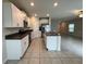 Open kitchen with granite countertops, white cabinets, stainless steel appliances, and modern fixtures at 4448 Globe Thistle, Tampa, FL 33619