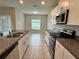 Well-lit kitchen with stainless steel appliances, granite counters, and a dining area at 4448 Globe Thistle, Tampa, FL 33619