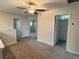 Upstairs landing with carpet, ceiling fan, and several bedroom doors at 4448 Globe Thistle, Tampa, FL 33619
