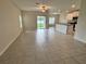 Open-concept living space with tile flooring leading to a backyard patio and modern kitchen at 4448 Globe Thistle, Tampa, FL 33619