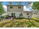 A well-manicured backyard with patio furniture and outdoor grill, perfect for entertaining at 4612 E Seneca Ave, Tampa, FL 33617