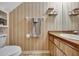 Cozy bathroom includes a toilet, cabinet with sink, and modern mirror and towel rack at 4612 E Seneca Ave, Tampa, FL 33617
