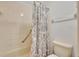 Bathroom with shower and tub featuring a patterned shower curtain at 4612 E Seneca Ave, Tampa, FL 33617