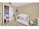 Comfortable Bedroom featuring a crib, closet and carpeted floor at 4612 E Seneca Ave, Tampa, FL 33617