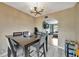 Neutral dining room with modern light fixture, opening to the living room, and a large dining table at 4612 E Seneca Ave, Tampa, FL 33617