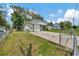 Two-story home featuring a fenced yard, garage and paved driveway at 4612 E Seneca Ave, Tampa, FL 33617