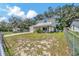 This two-story home boasts stone accents, a well-maintained yard, mature trees, and a fenced-in yard at 4612 E Seneca Ave, Tampa, FL 33617