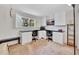 Bright home office with custom built-in cabinets, desks, and an open window at 4612 E Seneca Ave, Tampa, FL 33617