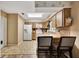 A vintage kitchen with wood cabinets, tile countertops, and modern appliances at 4612 E Seneca Ave, Tampa, FL 33617