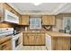 A vintage kitchen with wood cabinets, tile countertops, and an eat-in bar at 4612 E Seneca Ave, Tampa, FL 33617