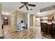 Open kitchen and dining area with wood-style flooring, vintage cabinets, and bright lighting at 4612 E Seneca Ave, Tampa, FL 33617